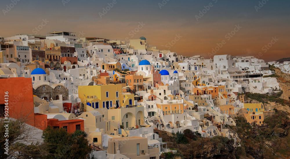 Panorama view in the sunset sky scene and blue dome church  at Oia village, Santorini,Greece