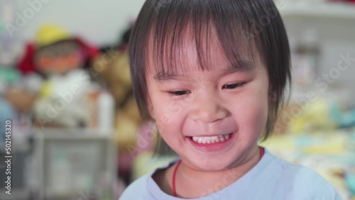 Father and son. Boy playing with balloons while laughing in the bedroom.