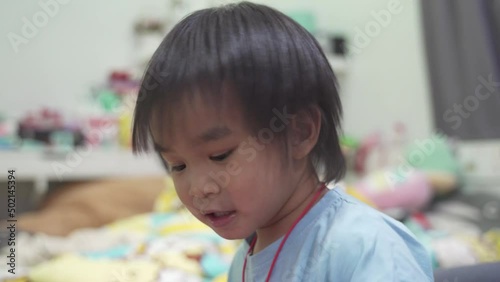 Father and son. Boy playing with balloons while laughing in the bedroom.