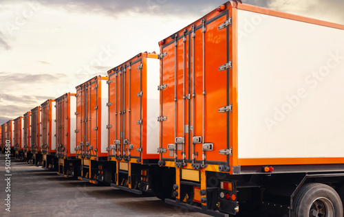 Row of Cargo Containers Trucks Parked Lot with Sunset Sky. Shipping Container Door Locked protect Safety. Industry Freight Trucks Logistics Cargo Transport. 