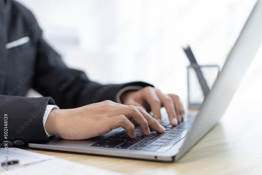 Businesswoman's hand presses on a laptop keyboard, World of technology and internet communication, Using computers to conduct financial transactions because the convenience and speed, Working concept.