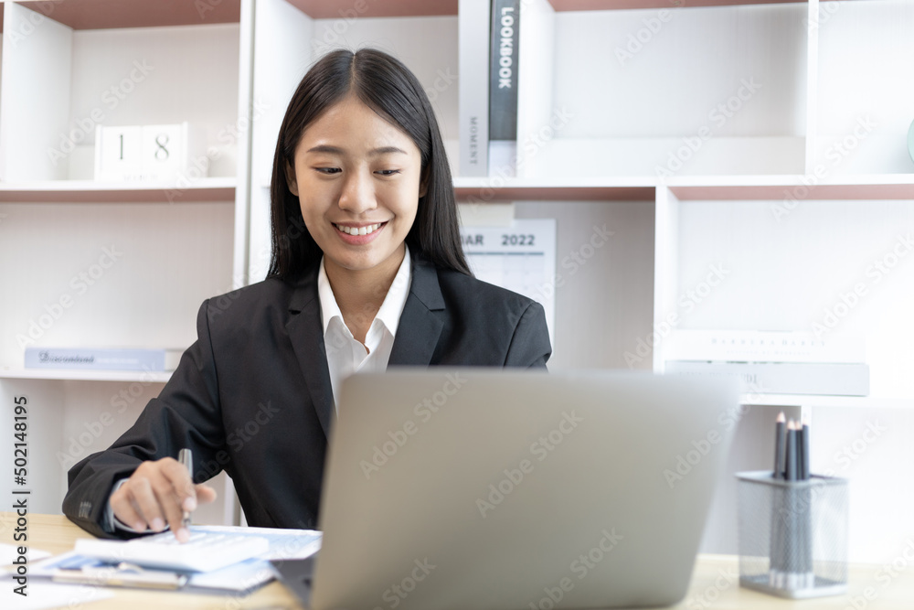 Businesswoman using laptop to work, Asian woman working in the office, World of technology and internet communication, Using computers to conduct financial transactions because the convenience. Businesswoman using laptop to work, Asian woman working in the office, World of technology and internet communication, Using computers to conduct financial transactions because the convenience.