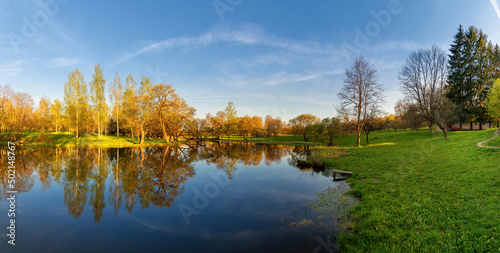 Beautiful colorful spring landscape with a lake in Park with many trees. Panoramic view