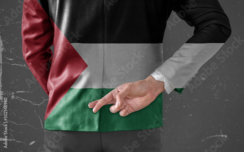 Businessman Jacket with Flag of Palestine with his fingers crossed behind his back