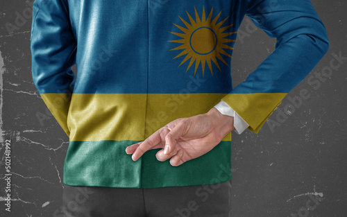 Businessman Jacket with Flag of Rwanda with his fingers crossed behind his back