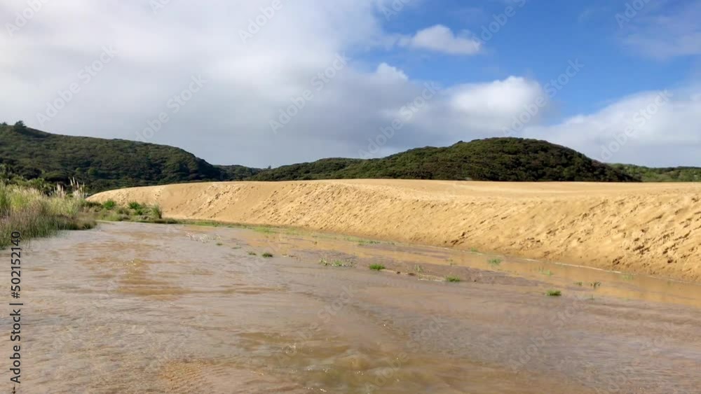 Te Paki Stream flows gently during the day  in Ninety Mile Beach Northland New Zealand