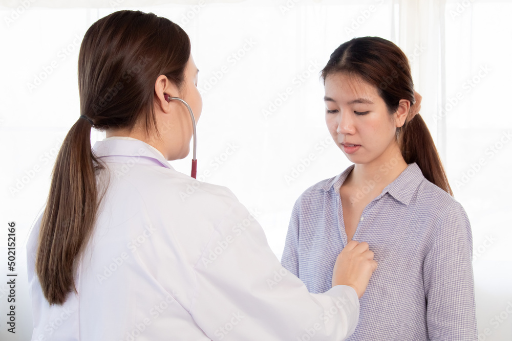 Young woman doctor in white uniform using stethoscope to check pulse female patient. Asian nurse measure heart rate by stethoscope at hospital. Medical insurance service concept. Young woman doctor in white uniform using stethoscope to check pulse female patient. Asian nurse measure heart rate by stethoscope at hospital. Medical insurance service concept.