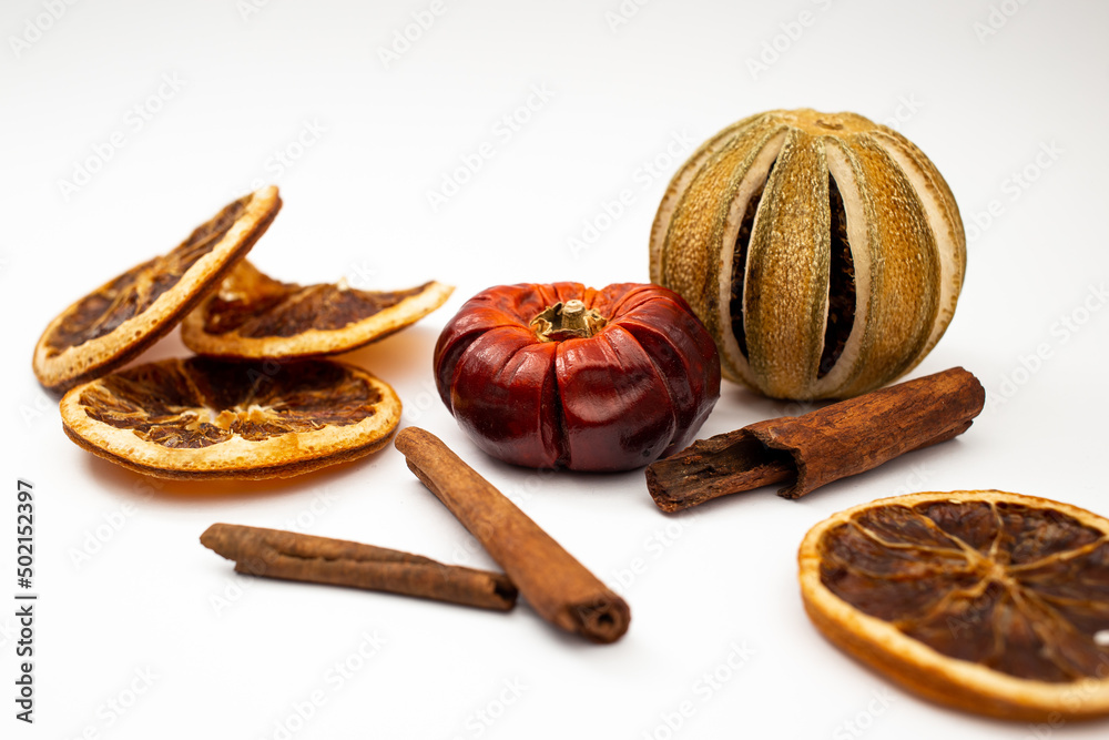 Dried fruit, fruit and cinnamon on white background