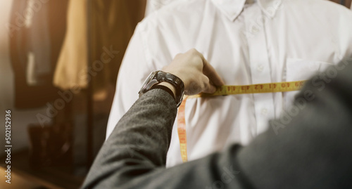 tailor's hands taking measurements