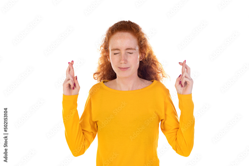 Hopeful pretty ginger girl curly hairstyle squinting praying cross fingers good luck awaiting important news willing wish come true achieve desire dream fulfill Hopeful pretty ginger girl curly hairstyle squinting praying cross fingers good luck awaiting important news willing wish come true achieve desire dream fulfill