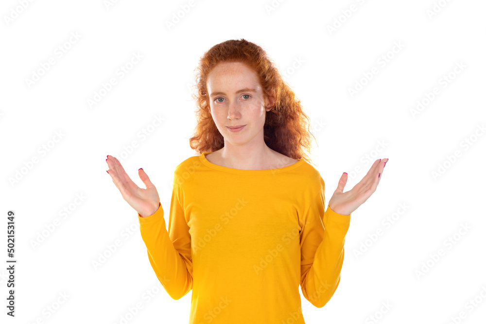Young redhead girl wearing yellow sweater over white background raising hands up Young redhead girl wearing yellow sweater over white background raising hands up