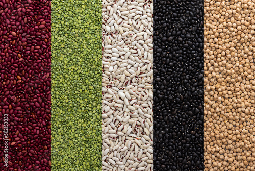 Different types of legumes, chickpeas and green peas, red, white and black beans, top view
