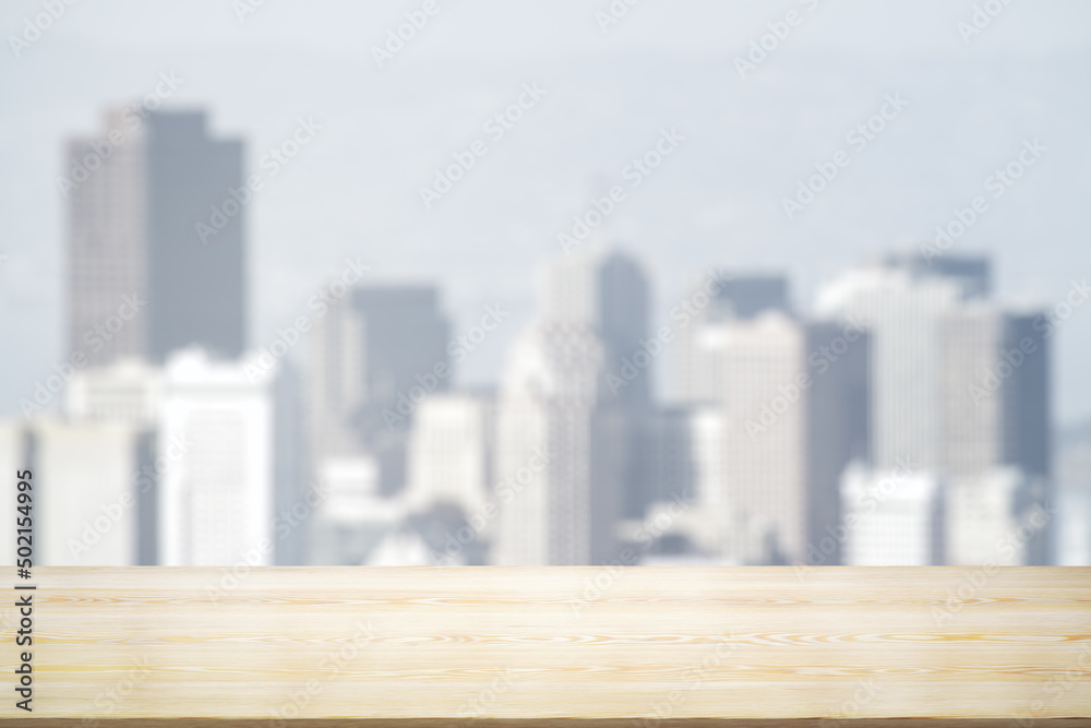 Blank wooden tabletop with beautiful blurry skyline in sunny weather on background, mockup