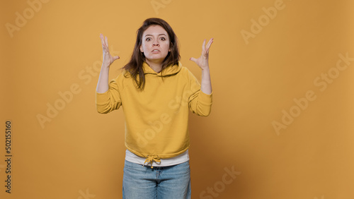 Cuadro en lienzo Portrait of angry woman feeling frustrated and mad doing exasperated hand gesture in studio