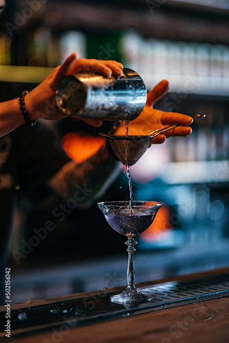 the bartender makes a cocktail