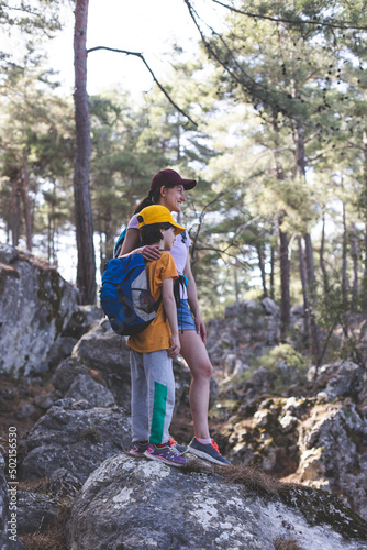 The boy with his mother go hiking