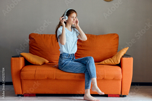 woman headphone at home on the couch entertainment apartments