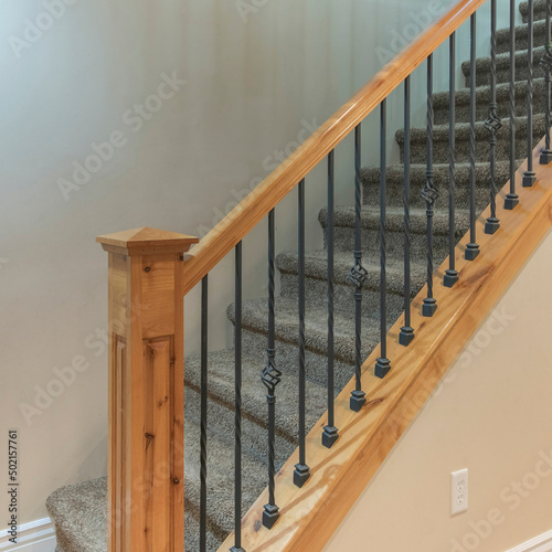 Fotografie, Obraz Square Carpeted stairs with wooden handrailing and wrought iron baluster