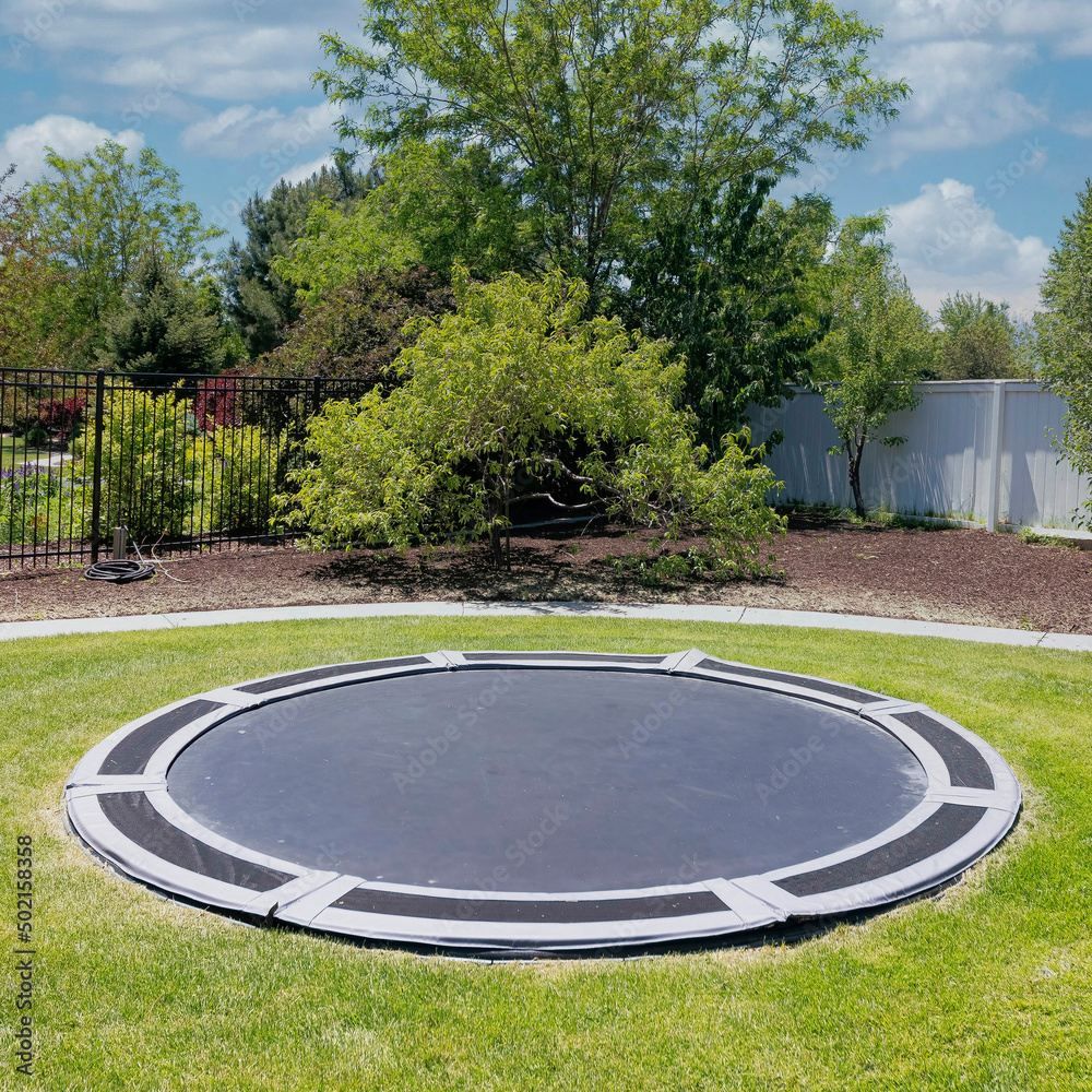 i mellemtiden fra nu af Afrika Square White puffy clouds In-ground trampoline on a lawn at the backyard in  Utah Stock Photo | Adobe Stock