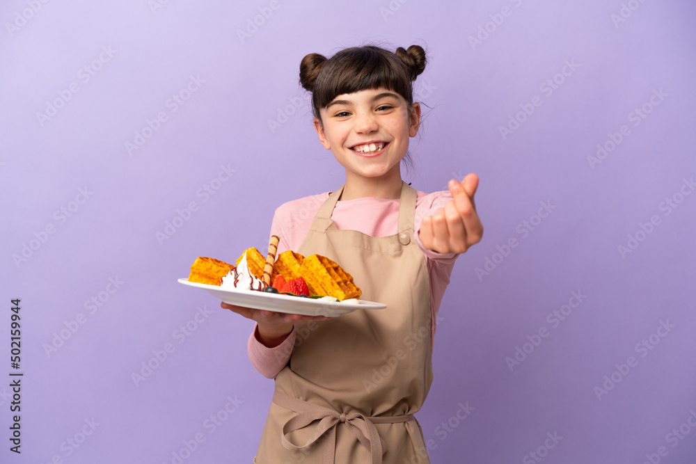 Little caucasian girl holding waffles isolated on purple background making money gesture Little caucasian girl holding waffles isolated on purple background making money gesture