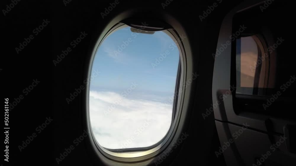 passenger window air flight with sea of clouds and blue clear sky, travel concept passenger window air flight with sea of clouds and blue clear sky, travel concept