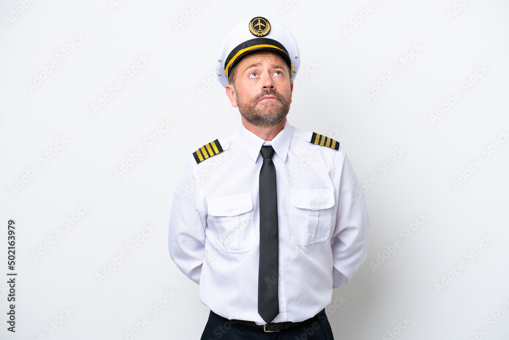 Airplane middle age pilot isolated on white background and looking up