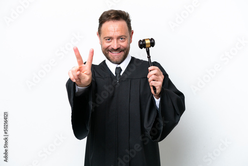 Middle age judge man isolated on white background smiling and showing victory sign