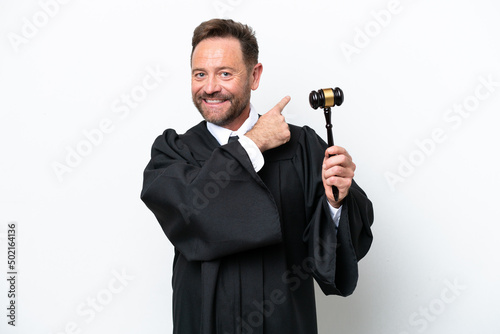 Middle age judge man isolated on white background pointing back