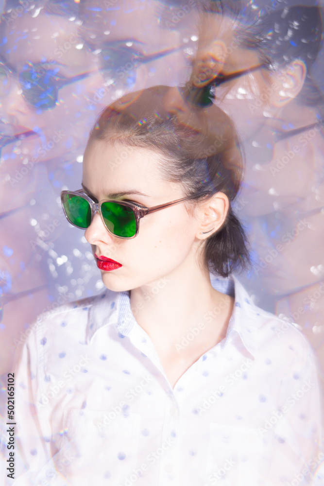 art portrait of a woman in green glasses with red lipstick on her lips in a white shirt