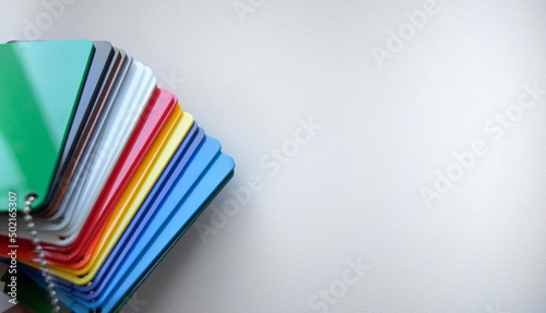 Layout of plastic of different colors on a white isolate.a clean place for the inscription. Sale of plastic materials. Color selection according to the layout. photo