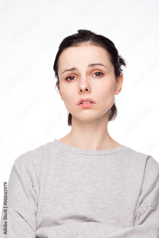 emotional woman in a gray sweatshirt, white background emotional woman in a gray sweatshirt, white background