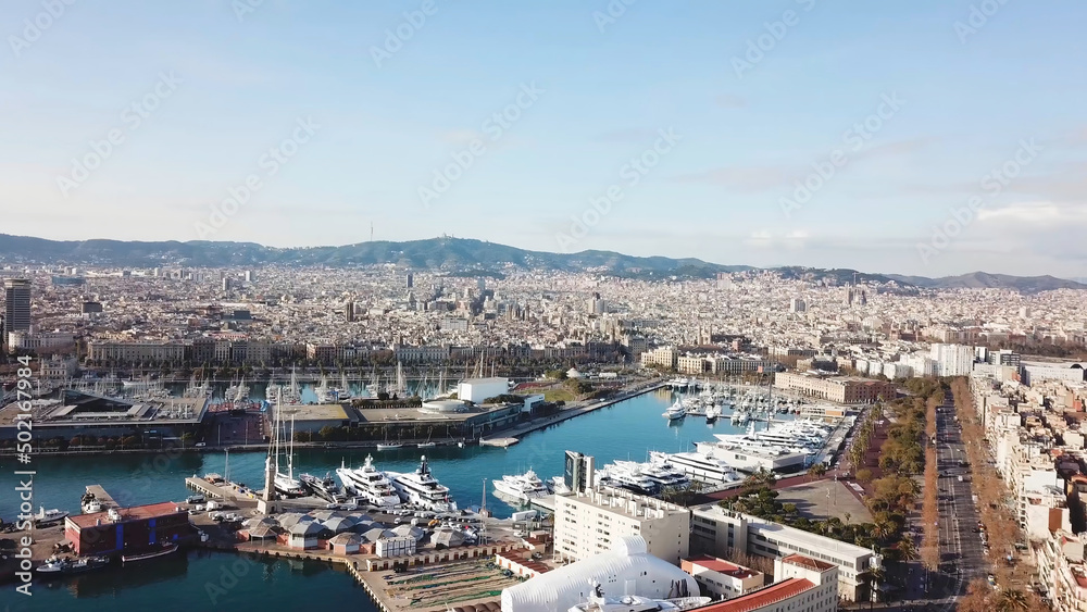 Top view of the city with the Bay and yachts. Stock. Beautiful aerial view of city port. Aerial view of white yachts and boats moored in harbour pier