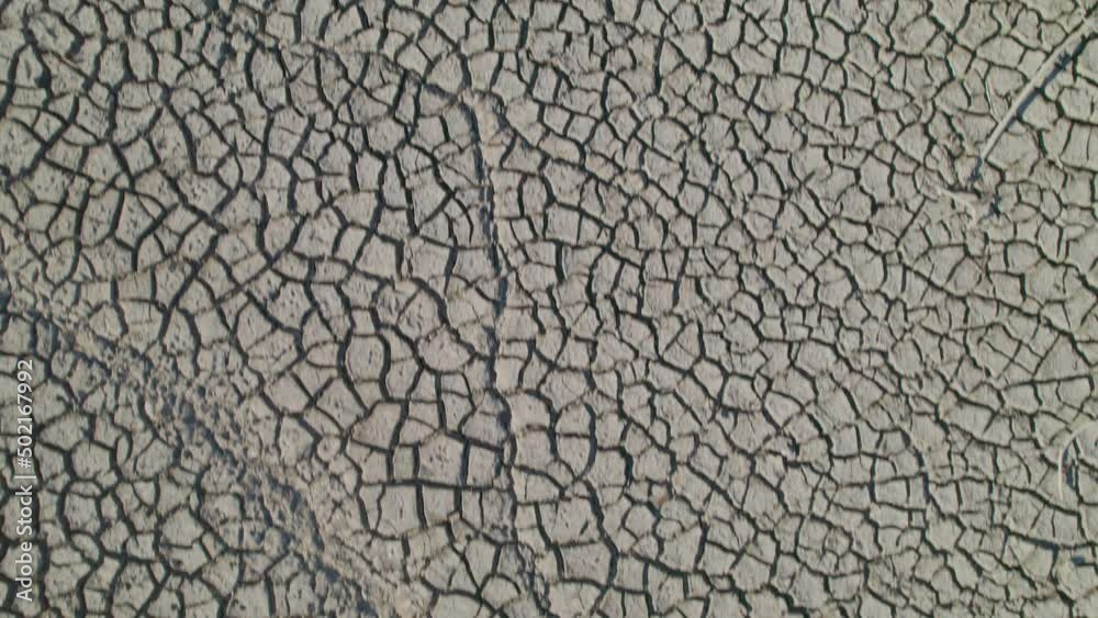 Dry soil with cracks through the mud in the desert during drought Dry soil with cracks through the mud in the desert during drought