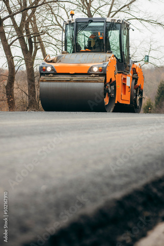 Vibratory asphalt rollers compactor compacting new asphalt pavement. Road service build a new highway 