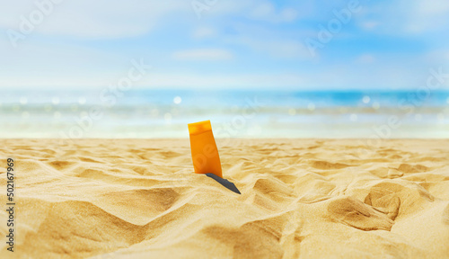 Принти на полотні Empty textured sand beach in front of summer sea with suncream bottles