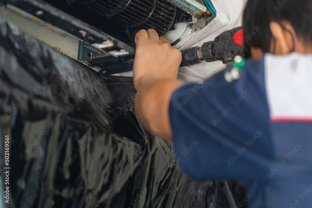 Air Conditioning Repair, Repairman fixing and cleaning air conditioning system, Male technician service for repair and maintenance of air conditioners