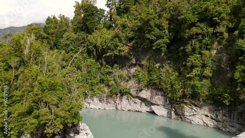 Young travelers on swing bridge at popular tourist attraction of pristine natural scenery. Hokitika Gorge scenic spot -aerial photo