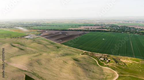 Aerial view of green agriculture fields with growing crops