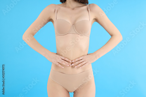 Concept of weight loss, young woman on blue background