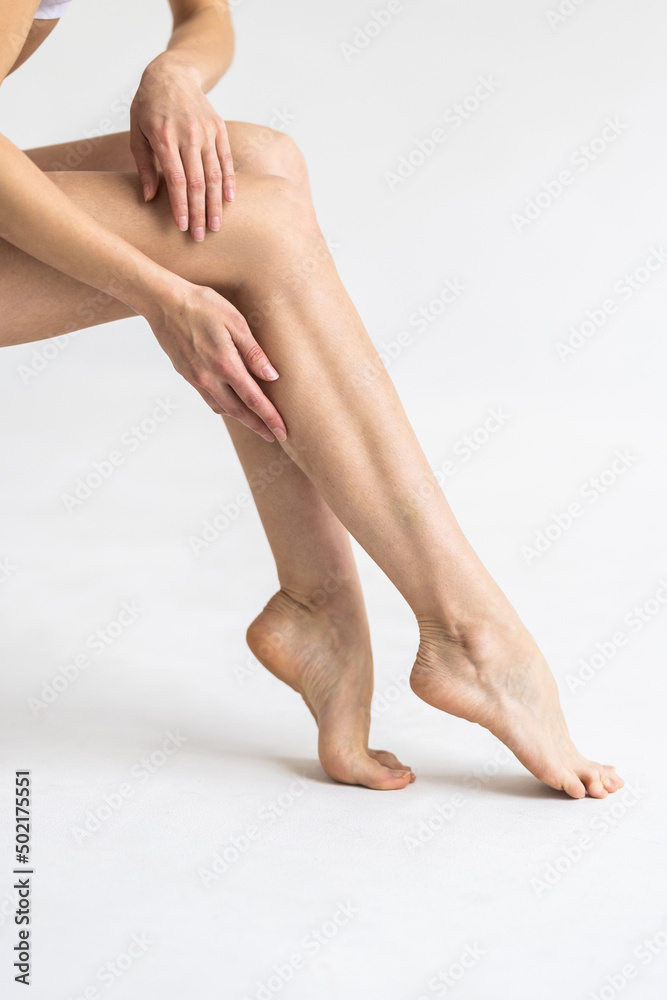 Beautiful woman legs on a white background. Body care. Beautiful woman legs on a white background. Body care.
