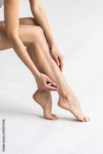 Closeup shot of beautiful female legs and hands. Hair removal concept