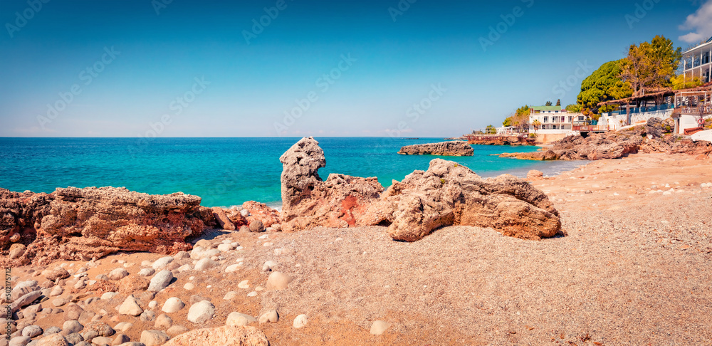 Panoramic summer view of publik beach in Dhermi town. Sunny morning seascape of Adriatic sea. Beautiful outdoor scene of Albania, Europe. Vacation concept background.