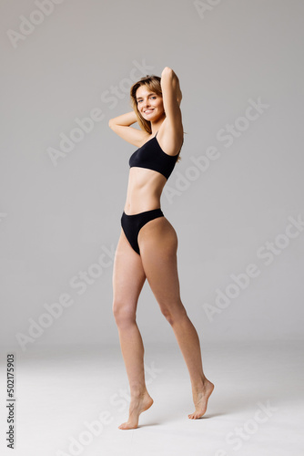 Girl with beautiful muscular body in black lingerie. Photo of smiling girl with perfect body. Fitness or plastic surgery concept © F8  \ Suport Ukraine
