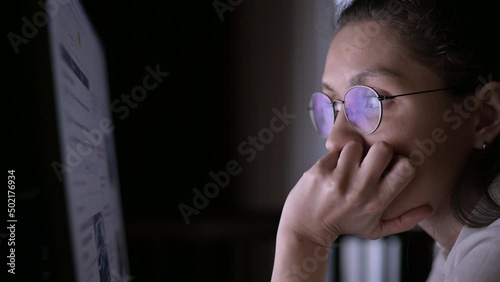 A young woman reads the news on a computer and is amazed at what is happening in the world. Wars, diseases and catastrophes, plane crashes, earthquakes, natural disasters