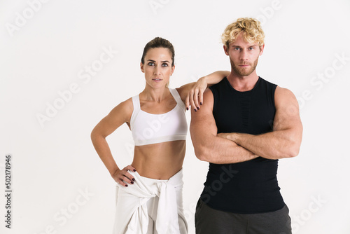 European couple in sportswear posing and looking at camera © Drobot Dean