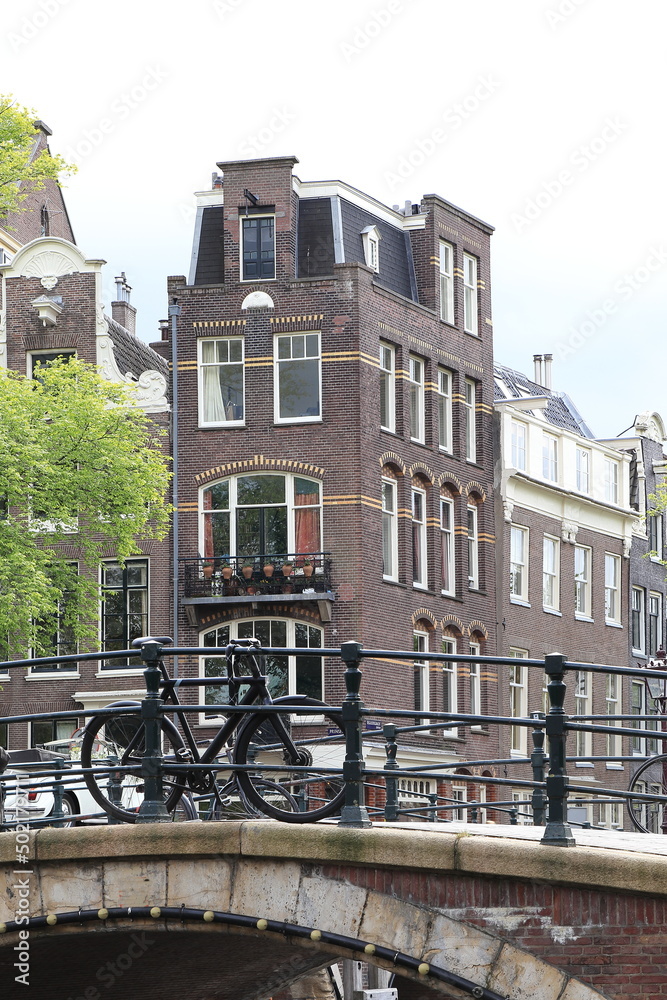 Reguliersgracht Bridge View with Bridge, Parked Black Bicycle and Traditional Canal Building, Netherlands