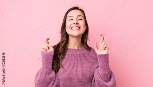 Canvastavla young pretty woman feeling nervous and hopeful, crossing fingers, praying and ho