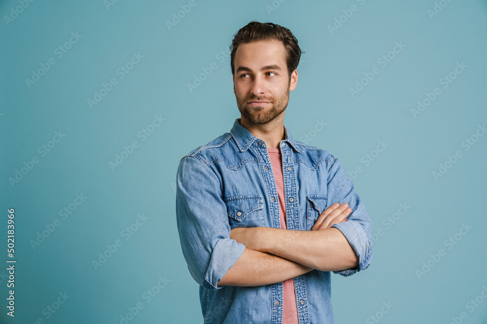 Young bristle man wearing shirt posing with arms crossed Young bristle man wearing shirt posing with arms crossed