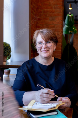 Portrait of pretty senior woman with wide smile having good time. Business Meeting