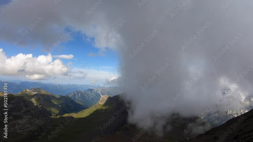 Time lapse in the Swiss Alps, the clouds move under the effect of the wind Time lapse in the Swiss Alps, the clouds move under the effect of the wind